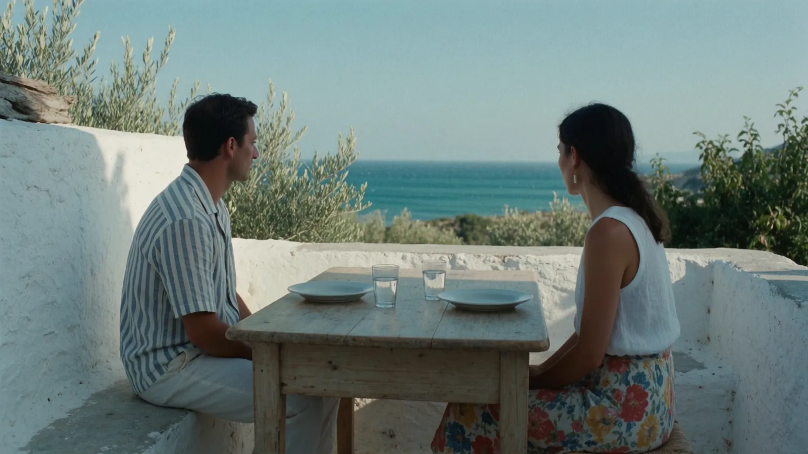 A couple lingering over lunch on a sea-view terrace on the Costa del Sol