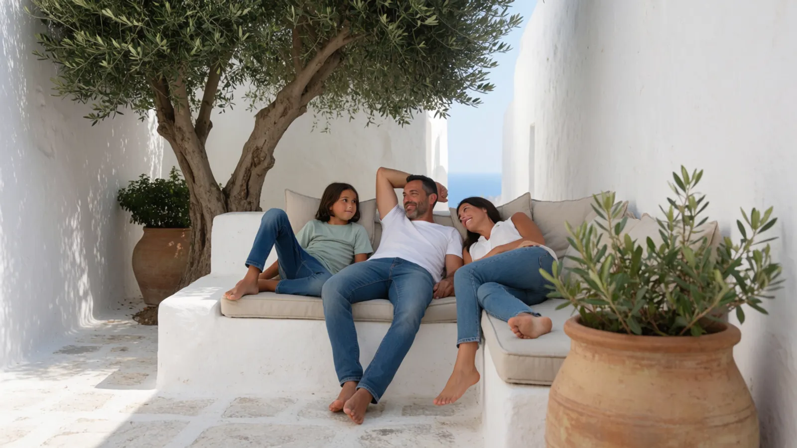 A family relaxing in a shaded whitewashed courtyard in southern Spain